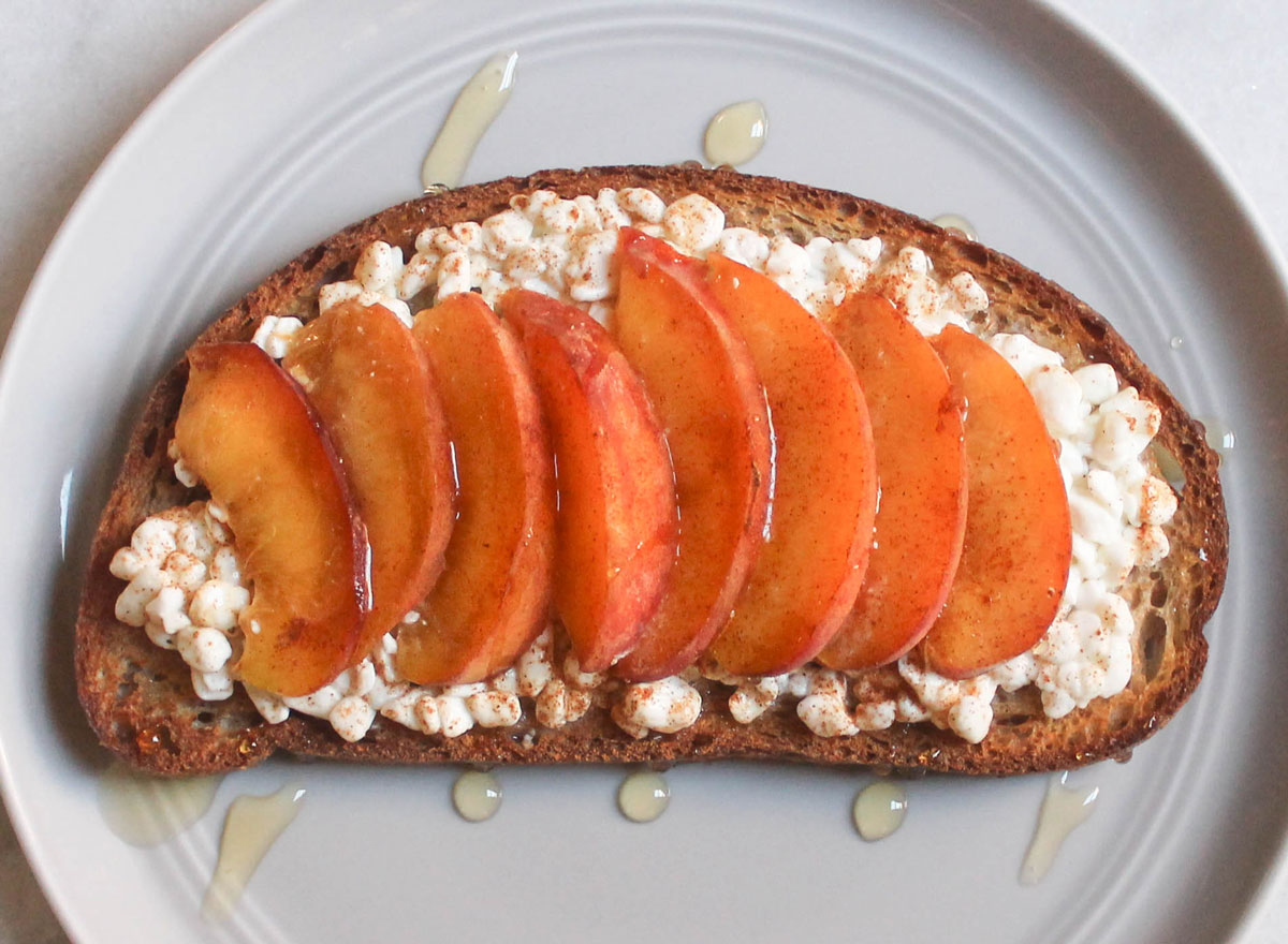 cottage cheese peach cinnamon honey toast on grey plate and marble counter
