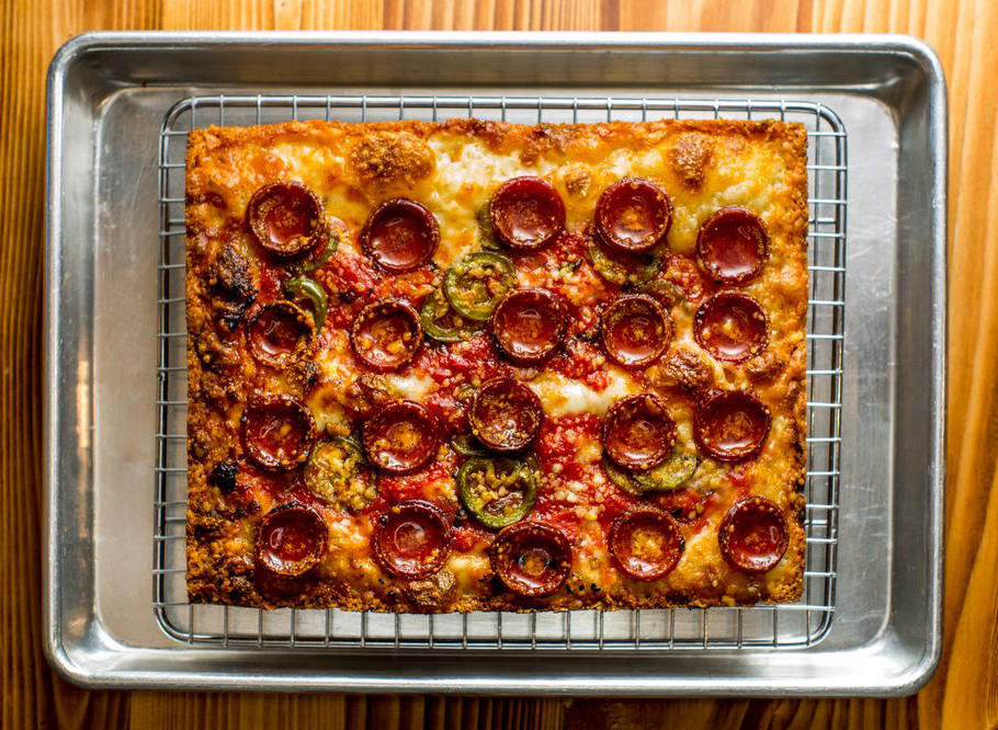 Detroit style pizza with large pepperoni slices from emmy squared