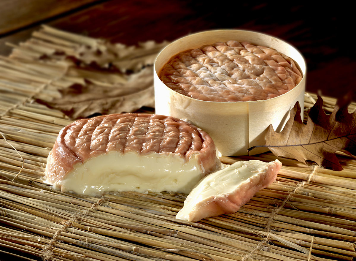 cut block epoisses cheese next to wheel