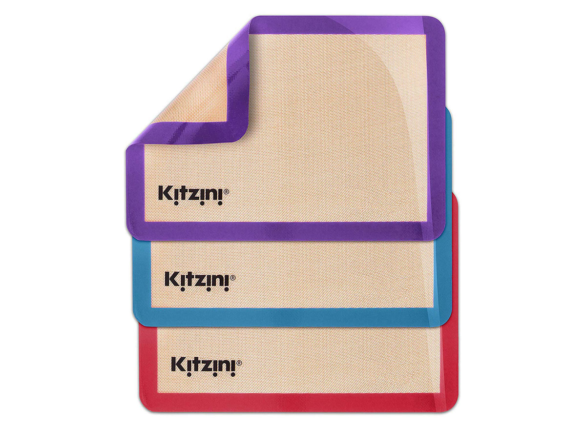 three kitzini silicone baking mats in purple, blue, and red