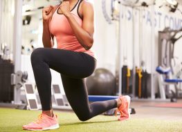 Woman doing lunges in a gym