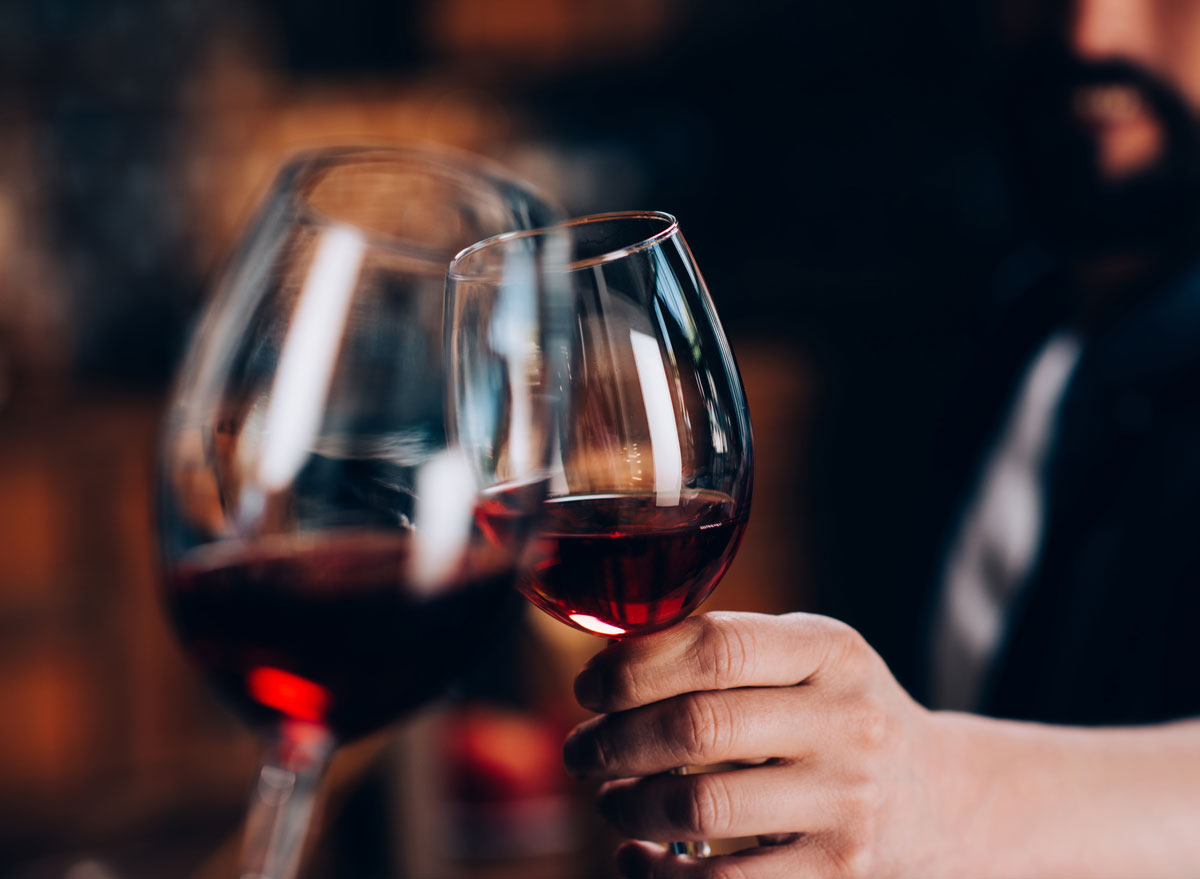 Man cheers glass red wine