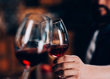 Man cheers glass red wine
