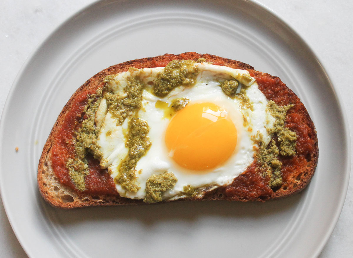 marinara pesto egg toast on grey plate and marble counter