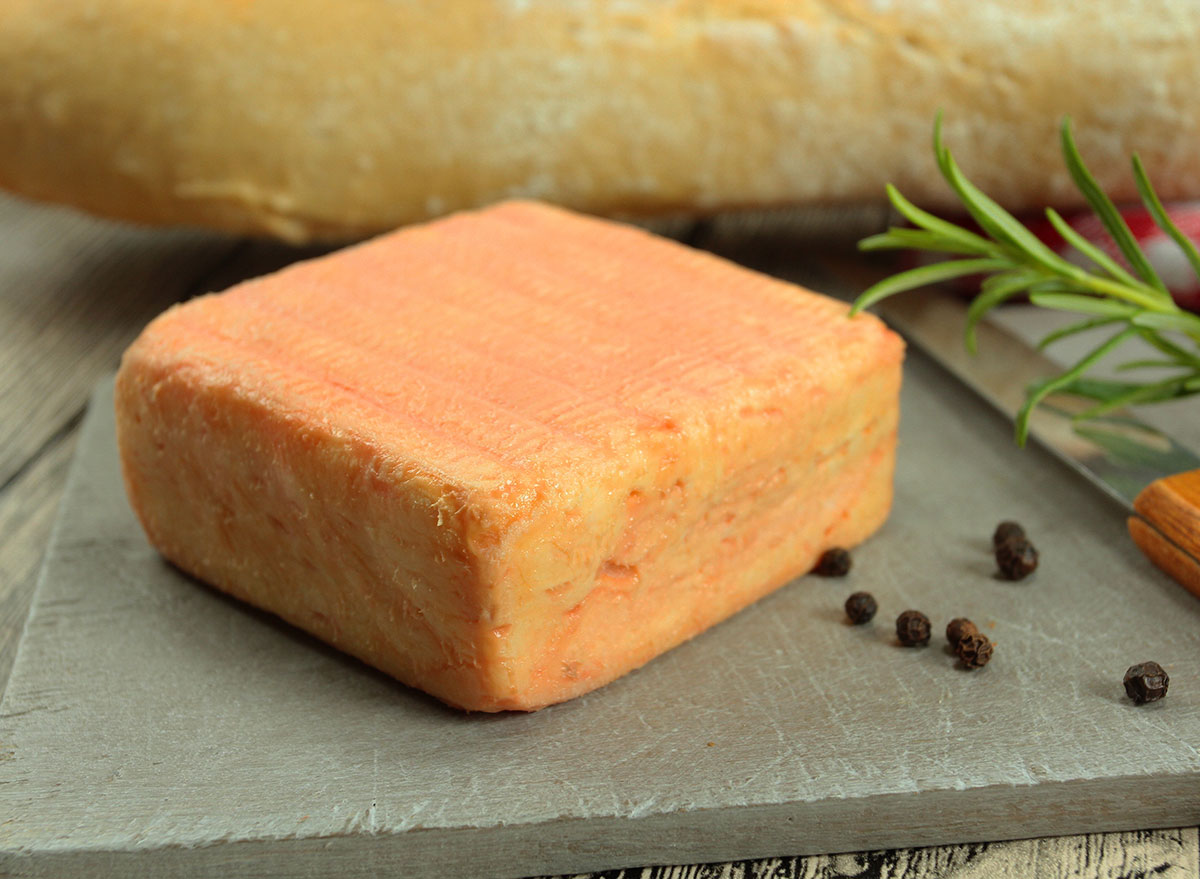 block of maroilles cheese on cutting surface