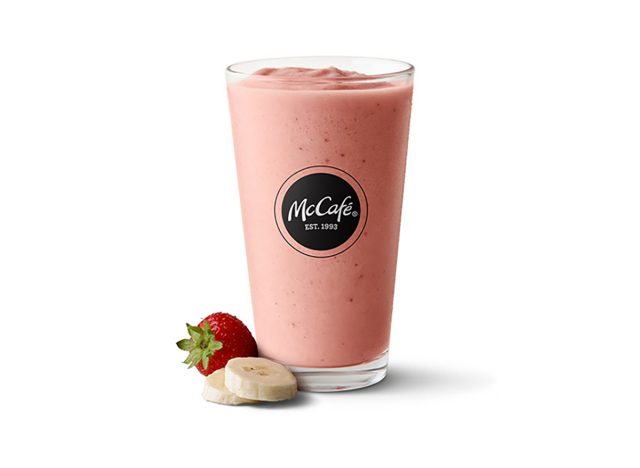 mcdonalds strawberry banana smoothie glass on white background