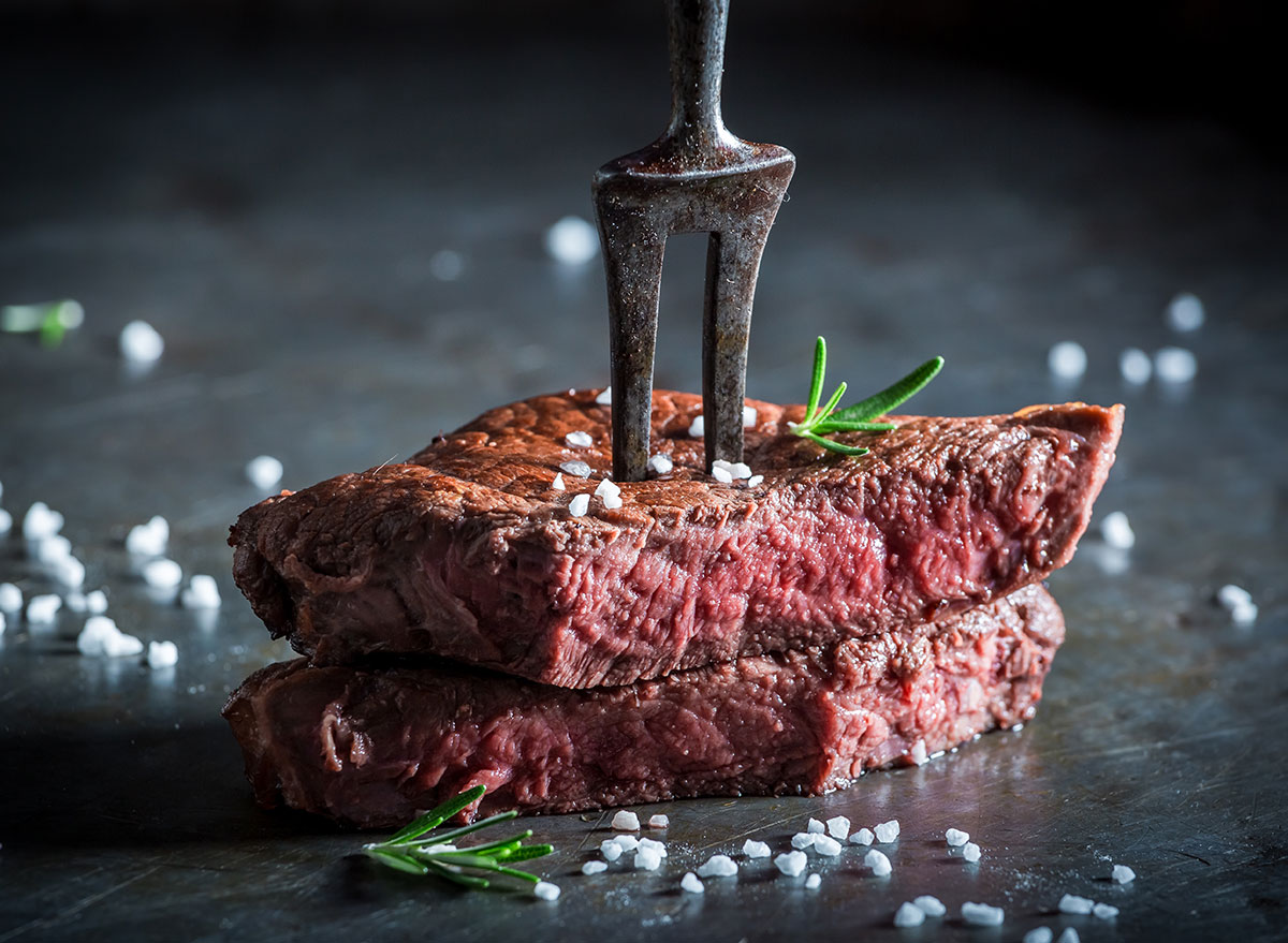 medium rare cooked steak metal fork with salt