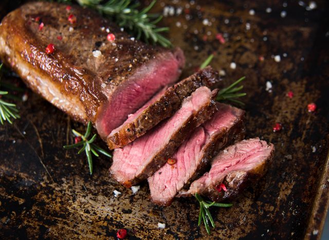 new york strip steak medium rare on baking sheet