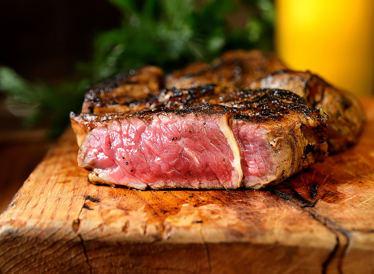 rare cooked steak on wooden cutting board