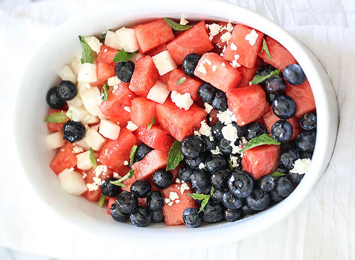 blueberry and watermelon salad in white bowl on white tablecloth
