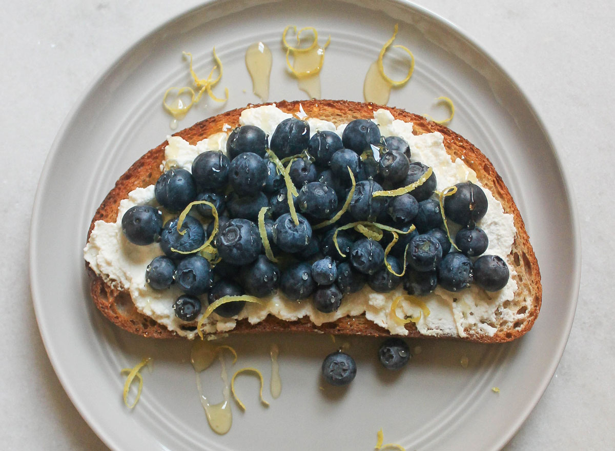 ricotta blueberry lemon honey toast on grey plate marble counter