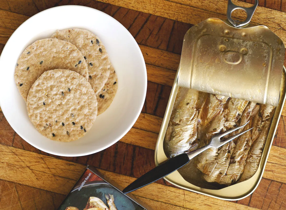 Sardines in tin next to flax crackers