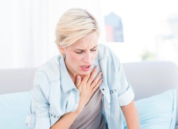 Woman having breath difficulties in the living room - Image