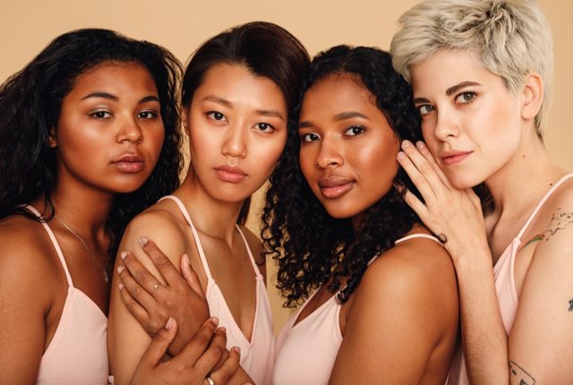 four women looking at camera