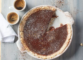 warm mocha tart with espresso cups and napkin