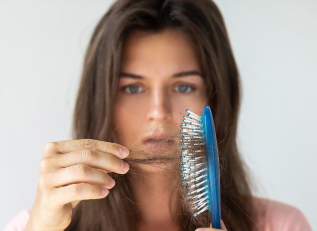 Young woman is very upset because of hair loss