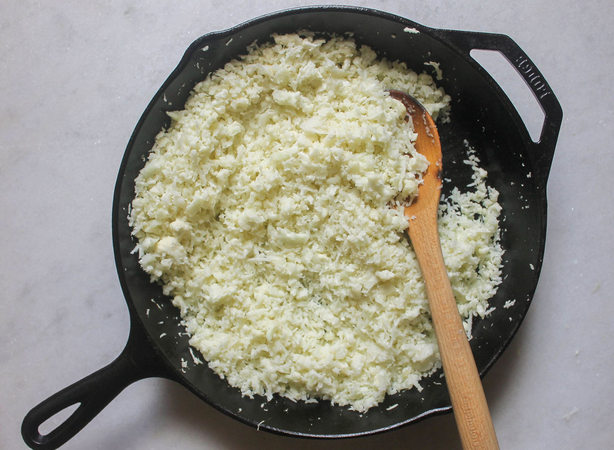 cauliflower rice cooked on a cast iron skillet