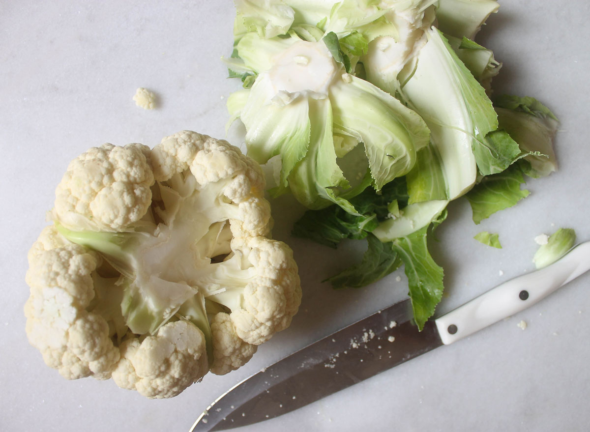 head of cauliflower with bottom cut off on a marble counter