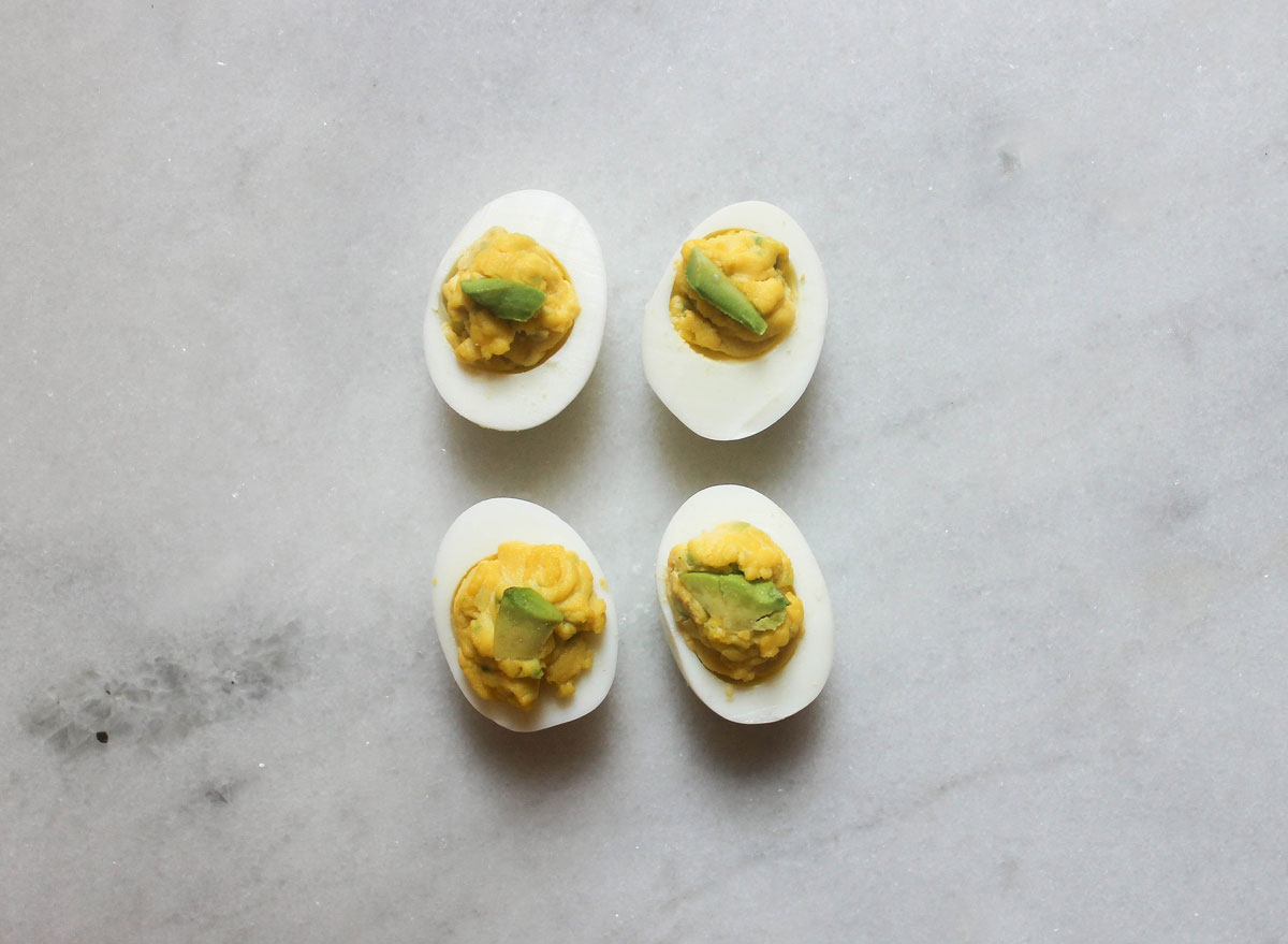 avocado deviled eggs on a marble counter