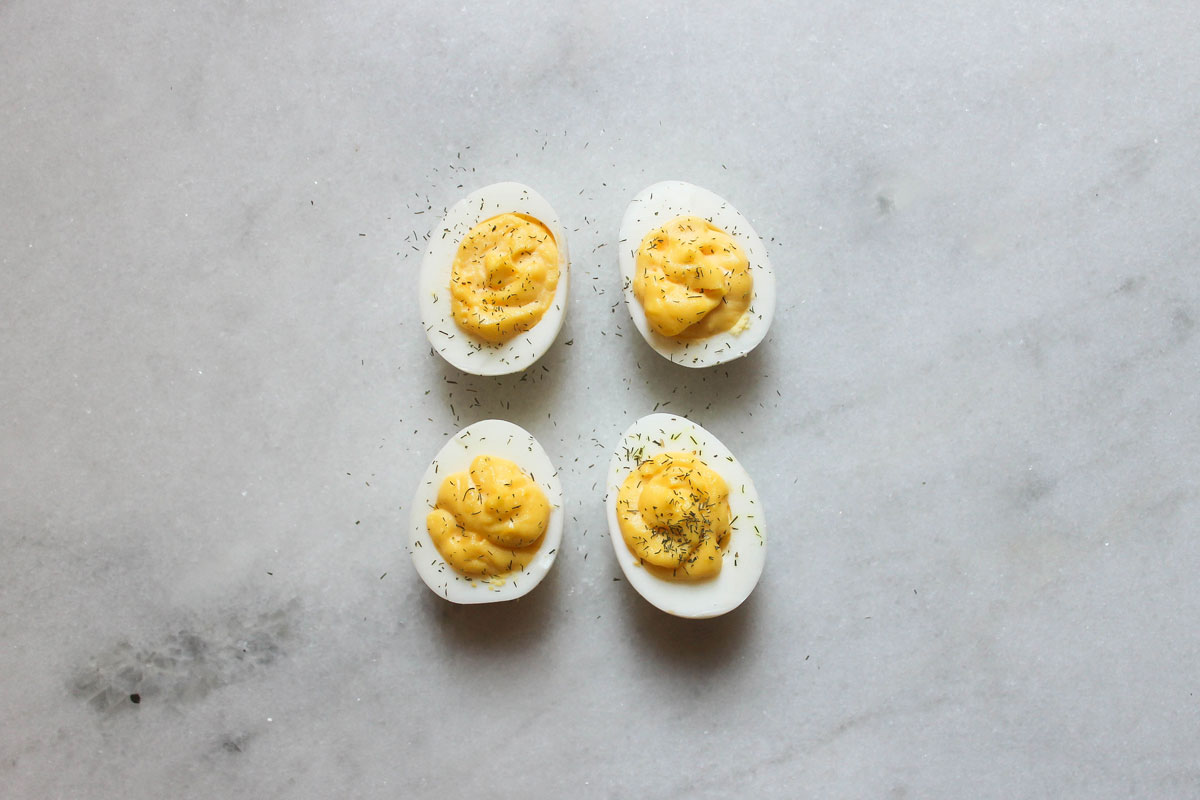 lemon dill deviled eggs on a marble counter