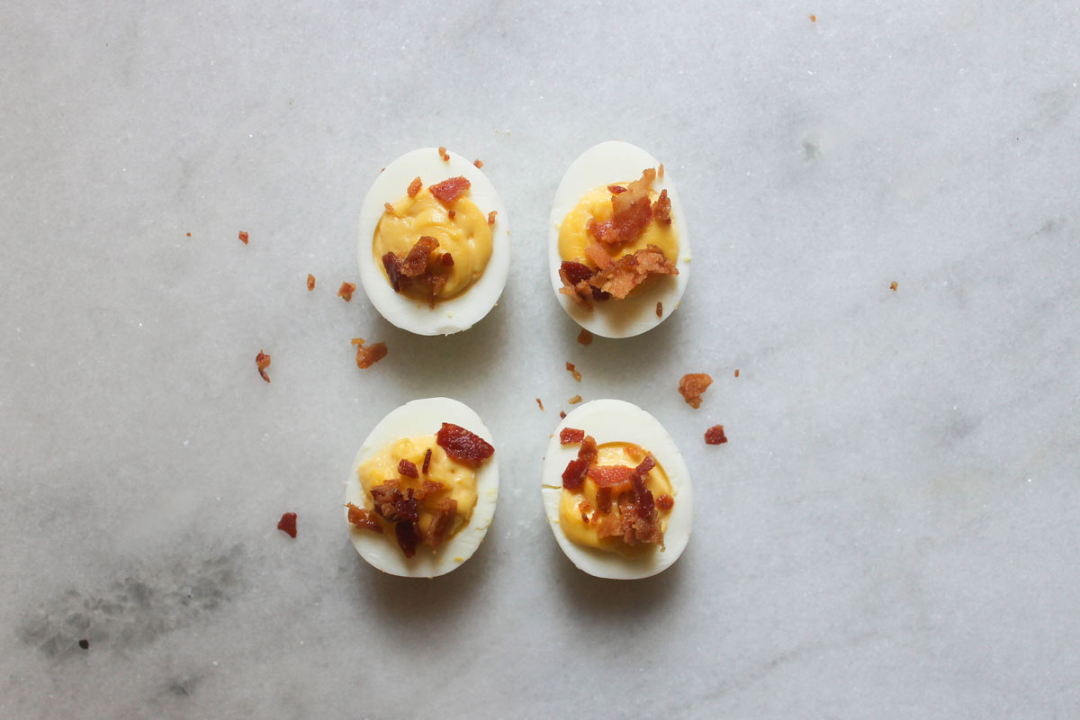 maple bacon deviled eggs on a marble counter