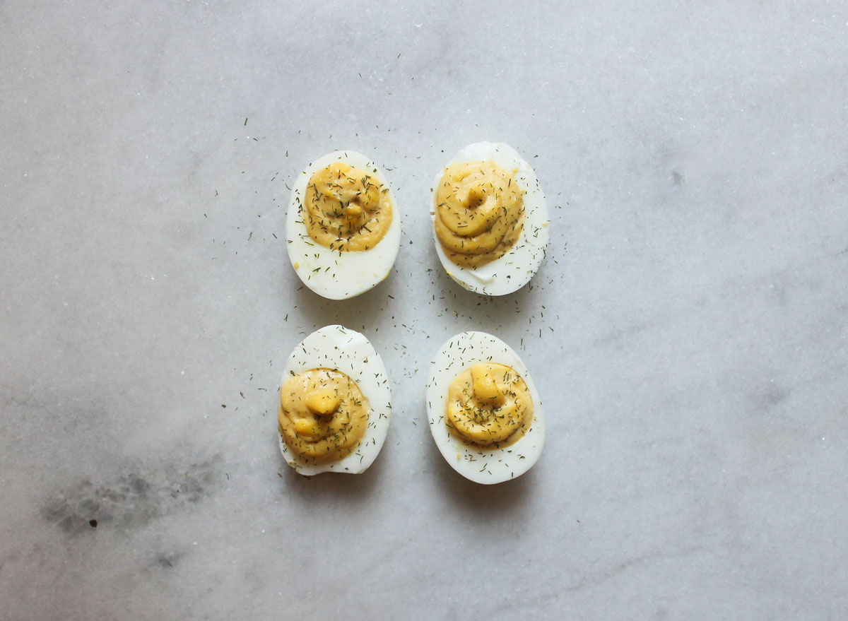 mustard dill deviled eggs on a marble counter