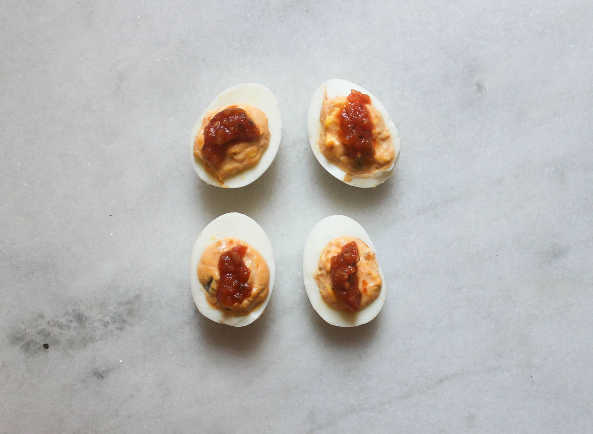 salsa deviled eggs on a marble counter