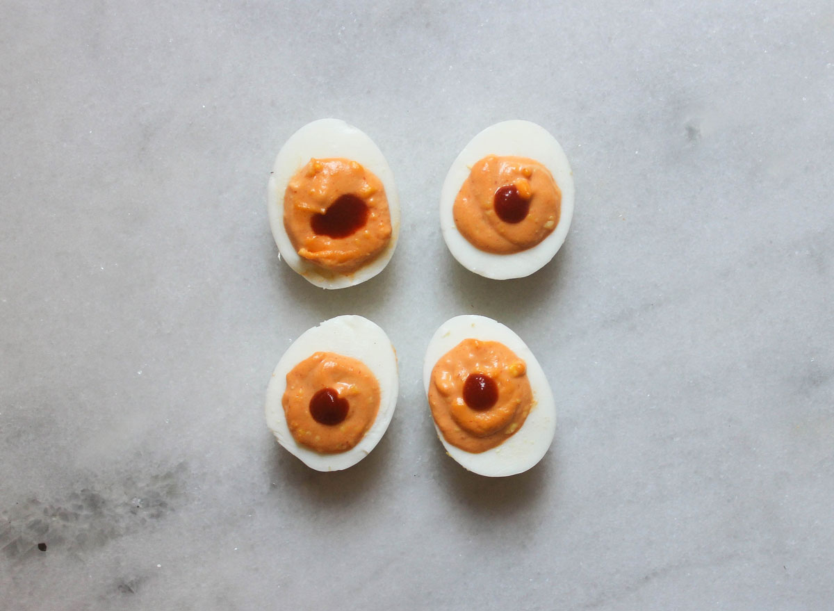sriracha lime deviled eggs on a marble counter