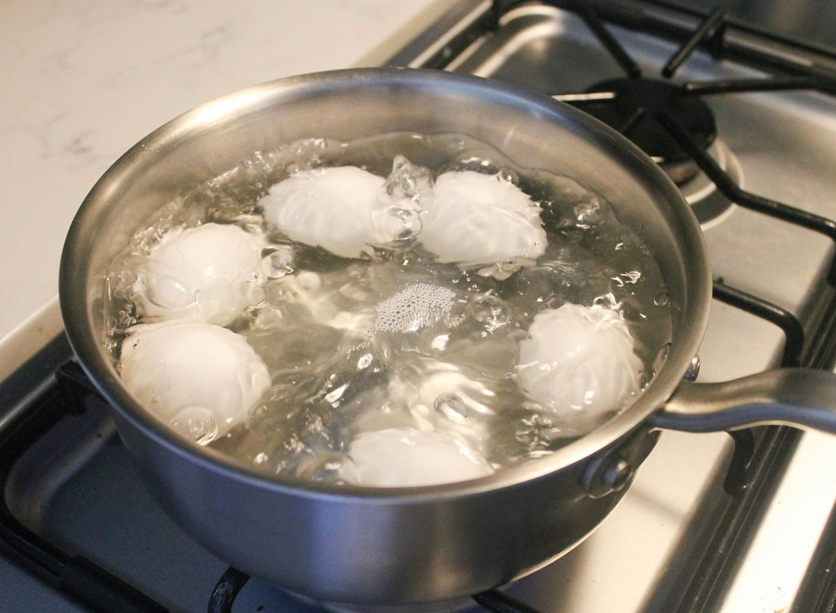 eggs boiling in a pot on the stove