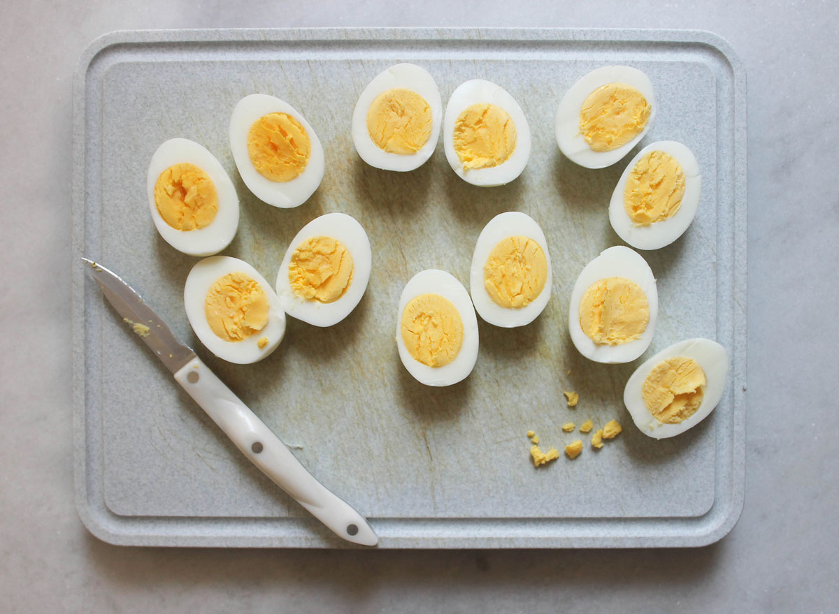 eggs peeled and cut up on a cutting board