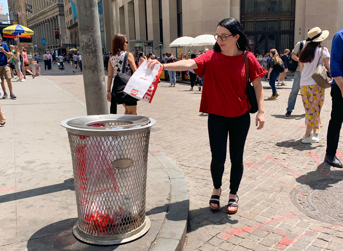 ann marie throwing away fast food bag on the street for fast food cleanse