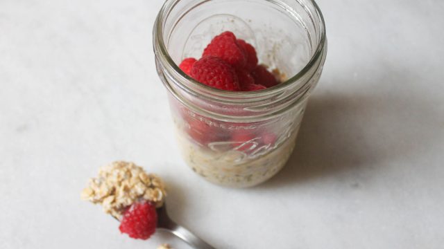 overnight oats finished with a spoon of oats on the marble counter