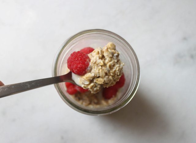 spoonful of overnight oats peanut butter on top of a jar