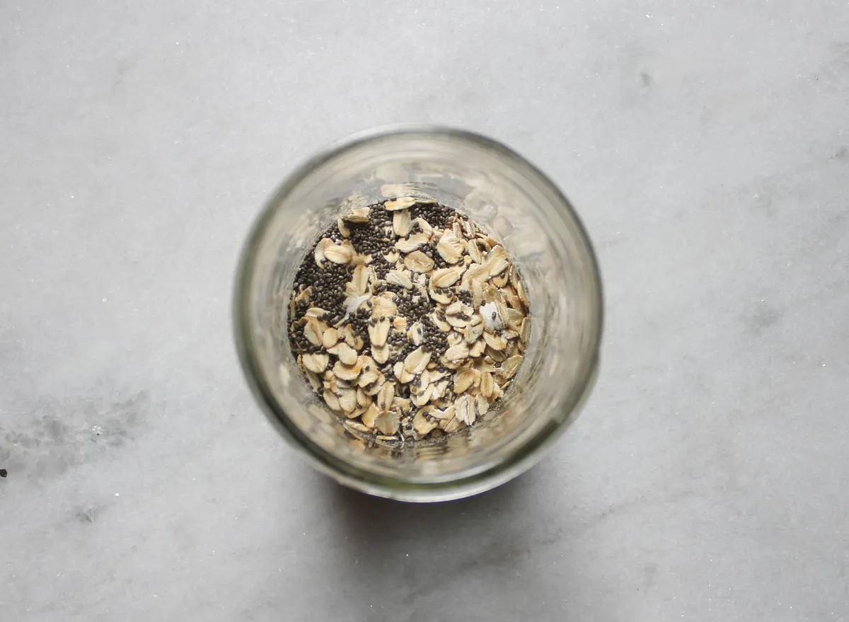 dry ingredients for overnight oats in a jar on a marble counter