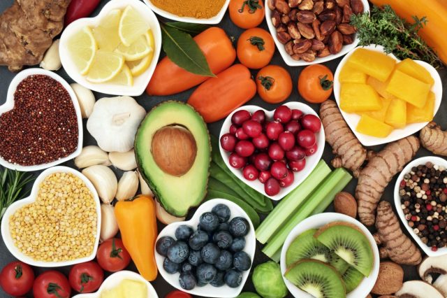 Health food for fitness concept with fruit, vegetables, pulses, herbs, spices, nuts, grains and pulses. High in anthocyanins, antioxidants, smart carbohydrates, omega 3, minerals and vitamins