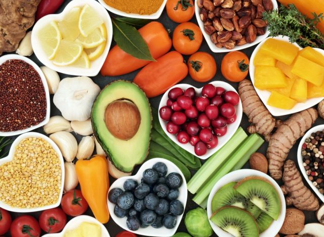 Health food for fitness concept with fruit, vegetables, pulses, herbs, spices, nuts, grains and pulses. High in anthocyanins, antioxidants, smart carbohydrates, omega 3, minerals and vitamins