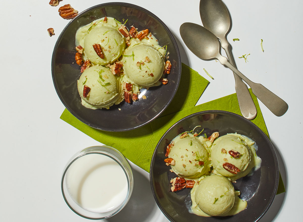 two bowls of avocado ice cream with spoons