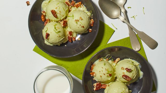 two bowls of avocado ice cream with spoons