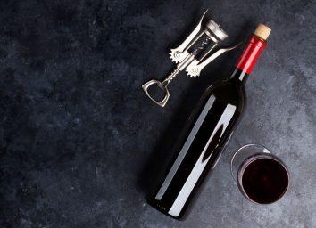 bottle of leftover red wine on a dark counter top