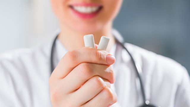 Doctor holding chewing gum for weight loss