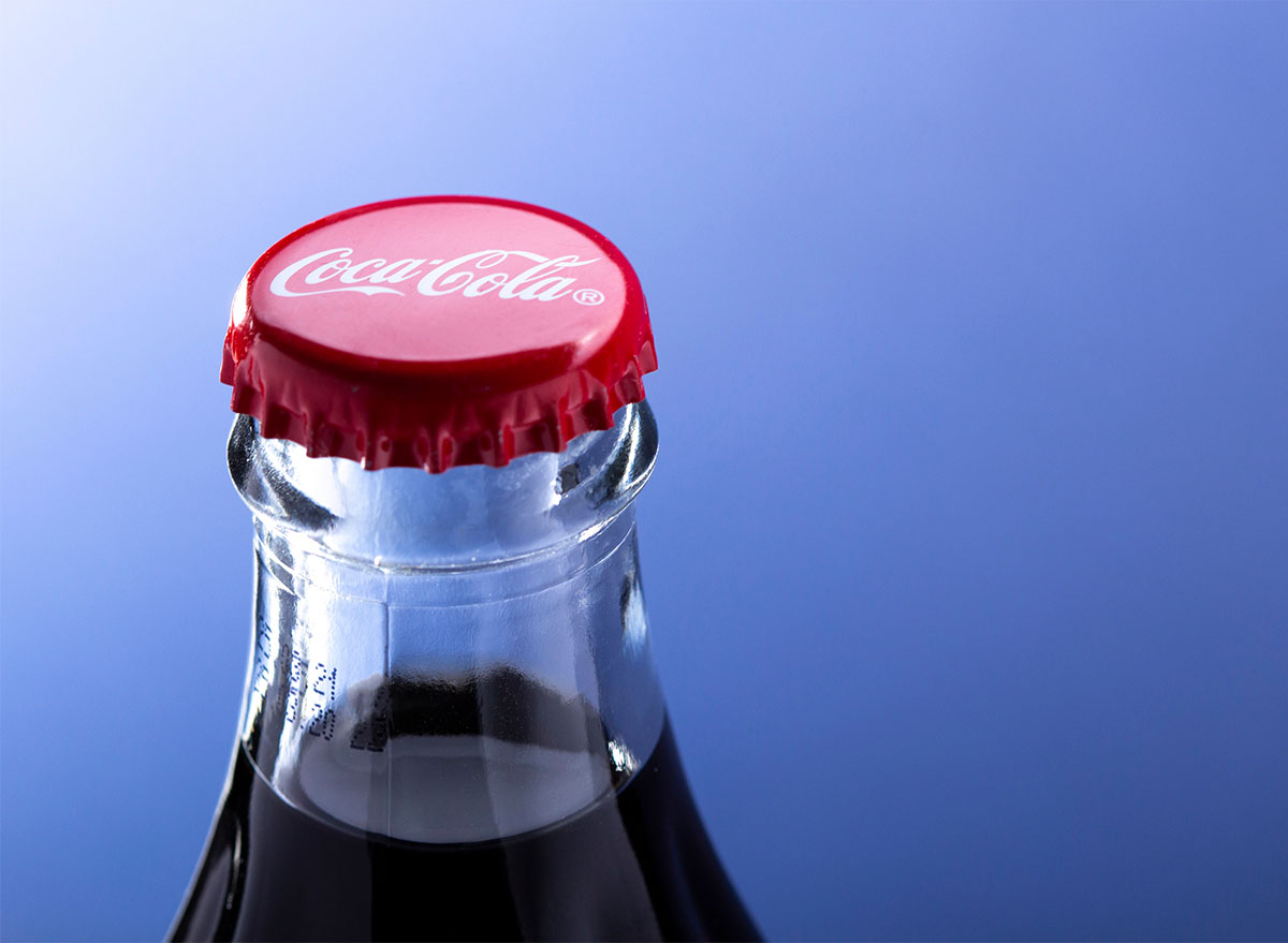 closeup on top of coke bottle with red cap