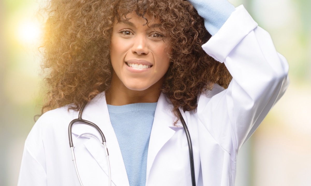 African american doctor woman touching her hair