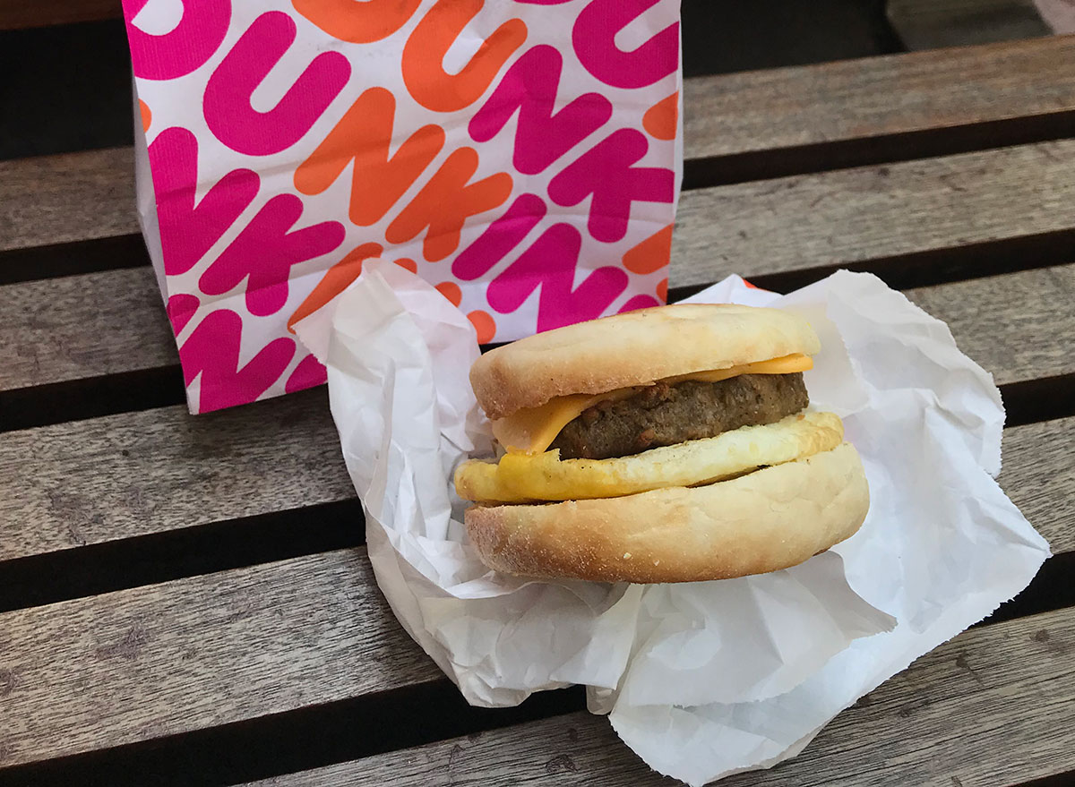 dunkin beyond meat sandwich on park bench