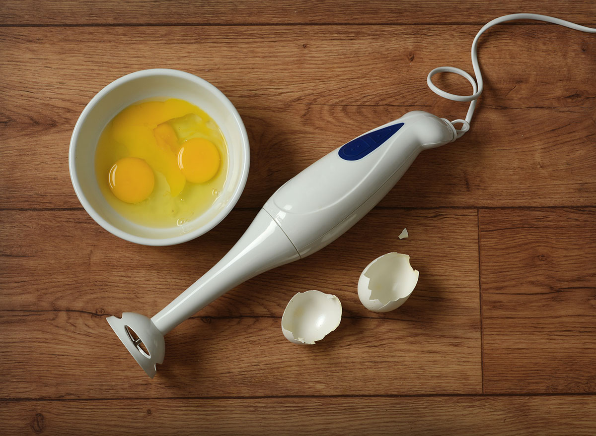 electric blender eggs on wooden table