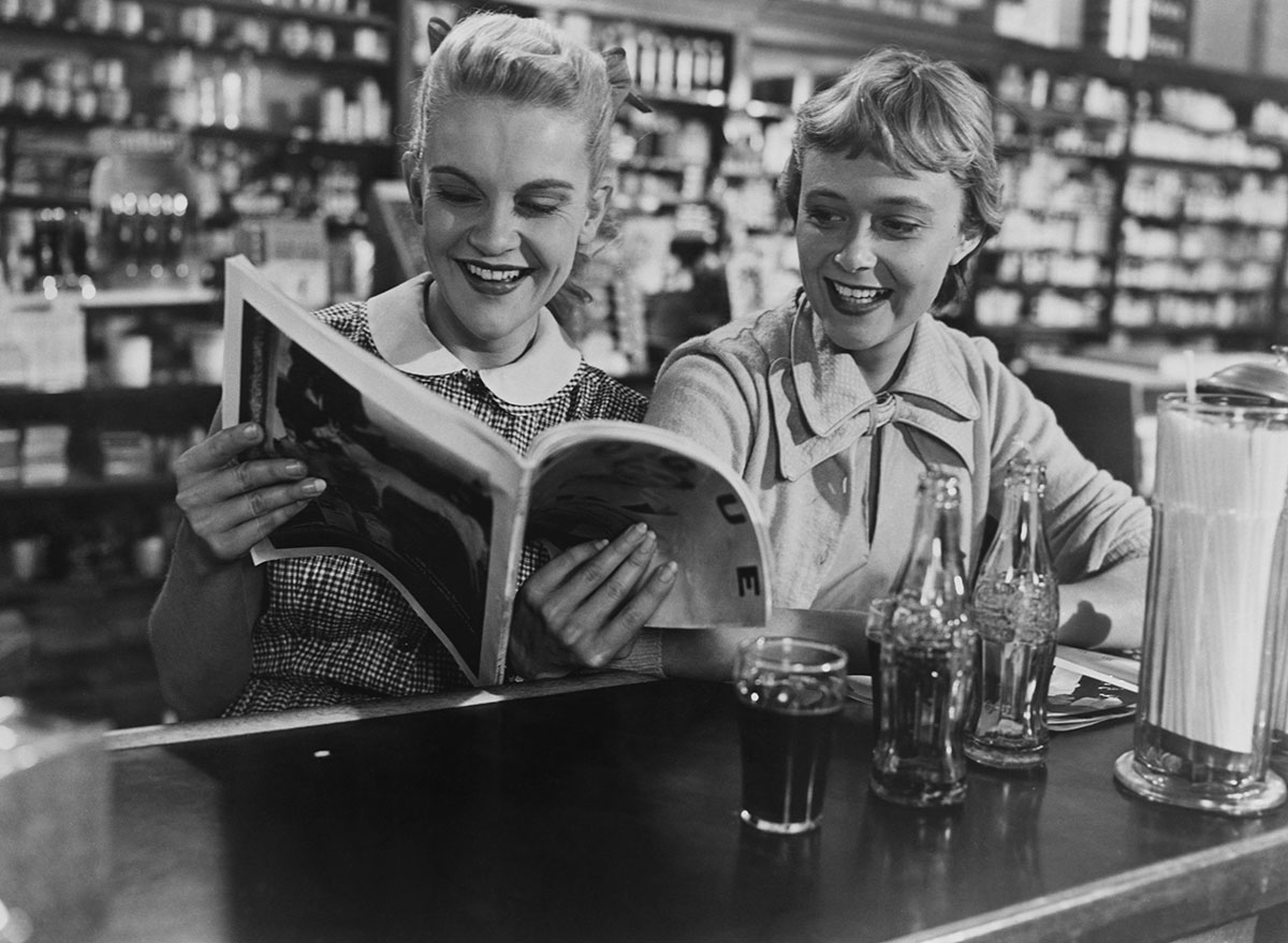 friends at old fashioned diner drinking soda