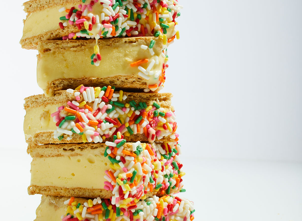 frozen lemon sandwich dessert with sprinkles in front of a white background