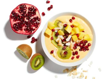 golden mango smoothie bowl with pomegranate and kiwi