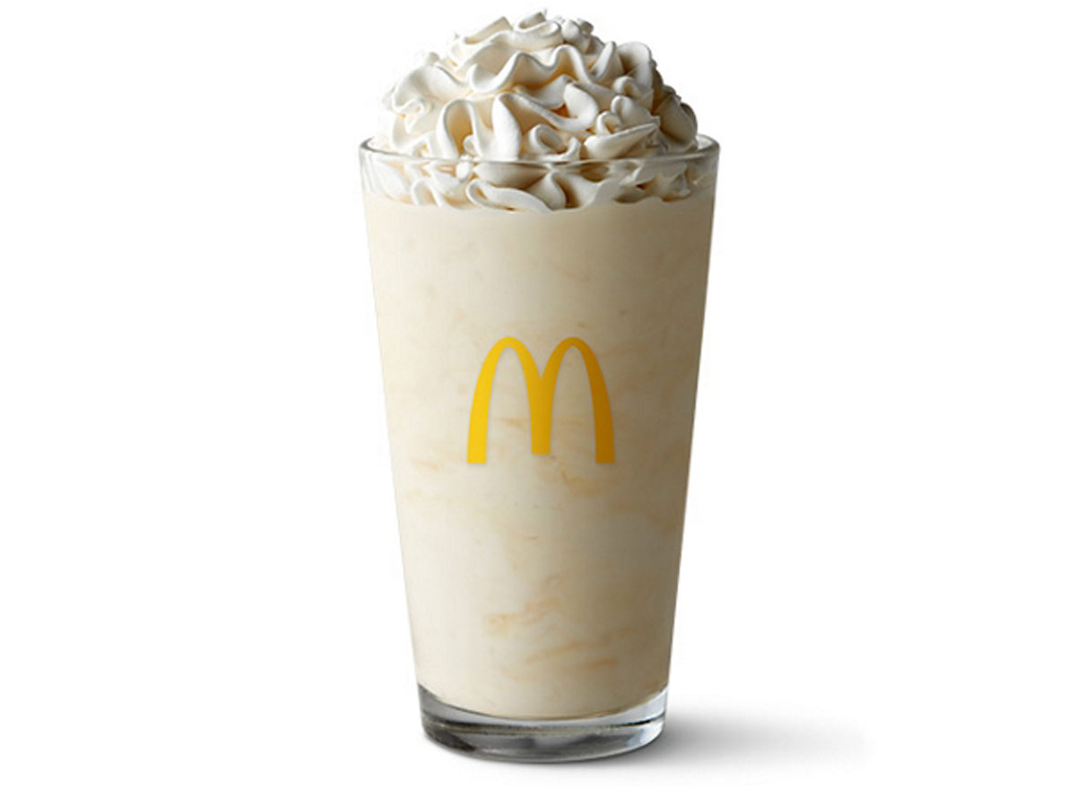 McDonald's vanilla milkshake with whipped cream on a white background