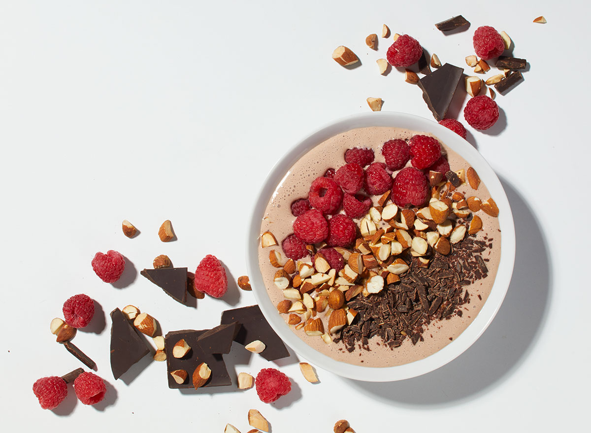 mexican chocolate smoothie bowl with raspberries and chopped chocolate