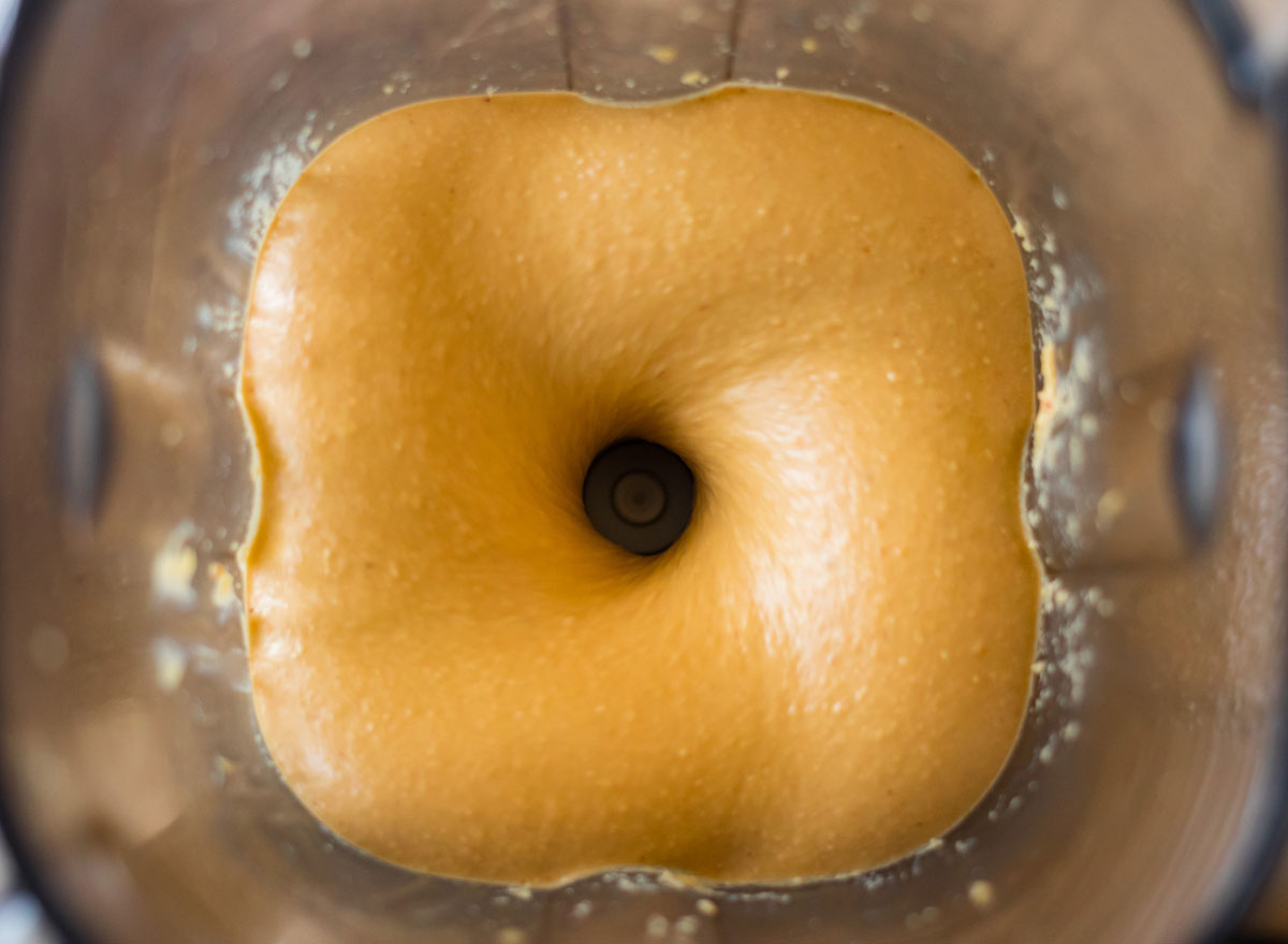 mixing peanut butter in a blender for homemade nut butter